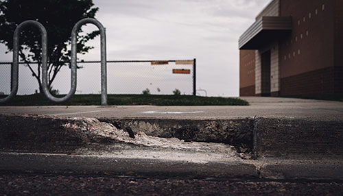 uneven curb by sidewalk